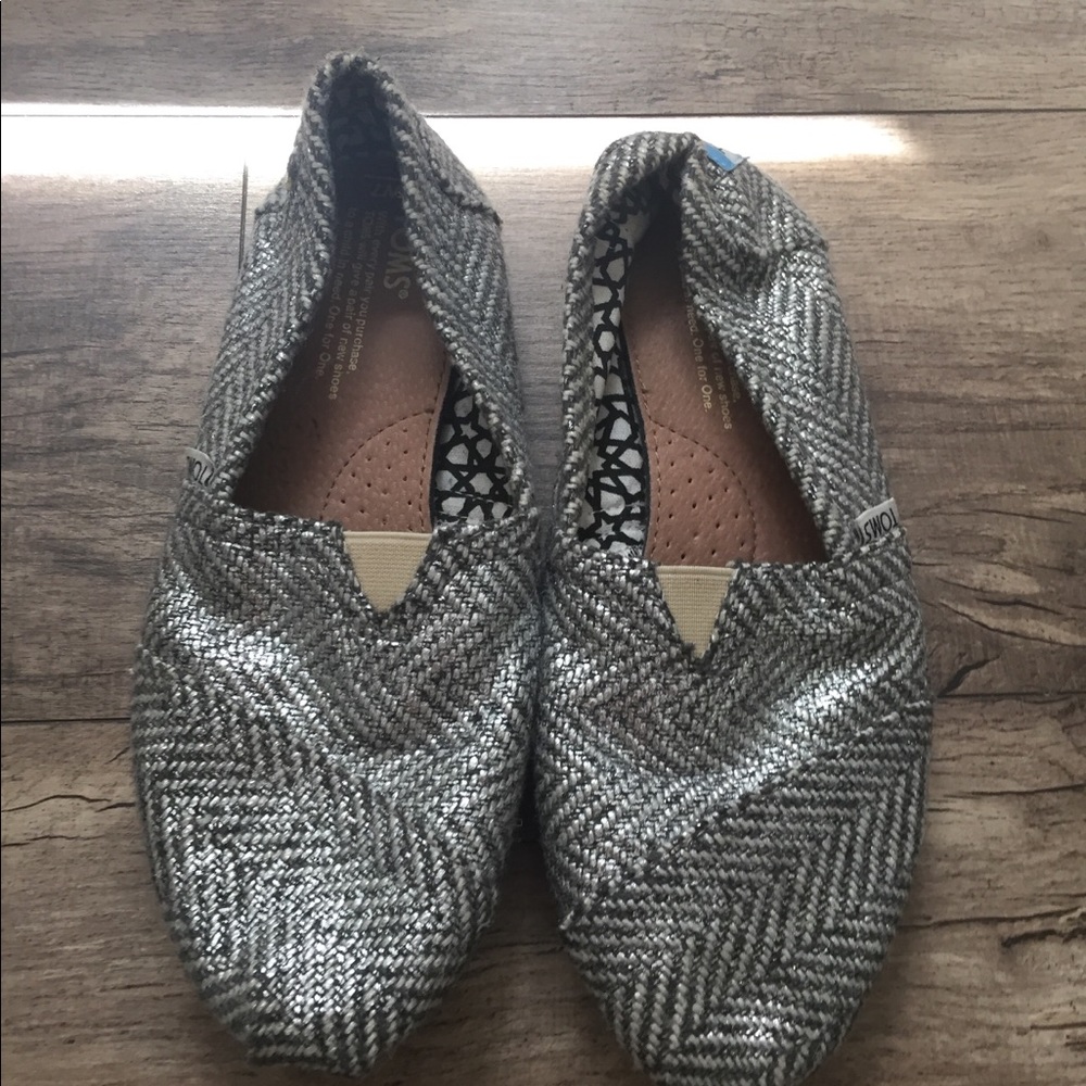 Silver and black Toms.